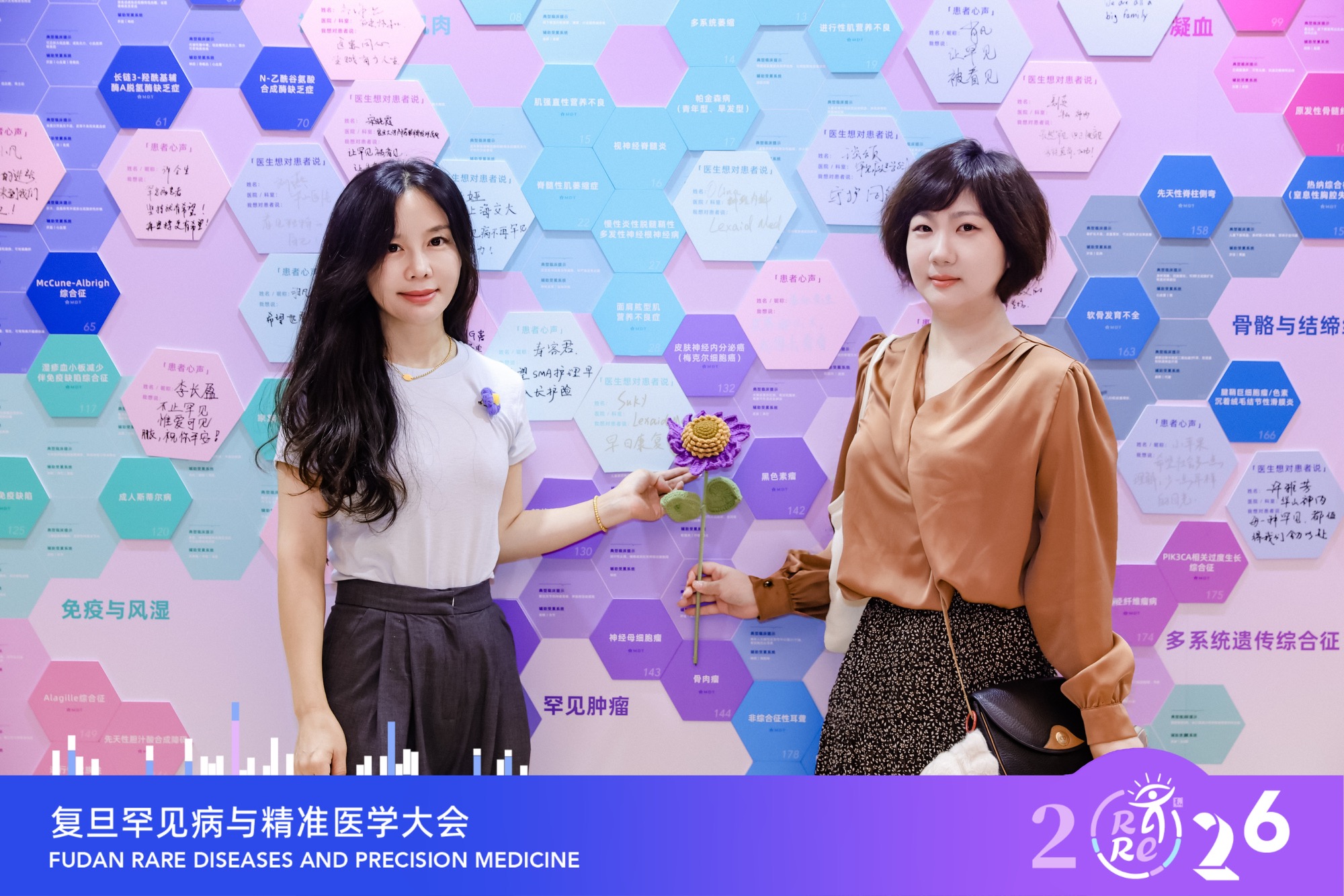 Lexaid founder and a team member at the conference message wall
